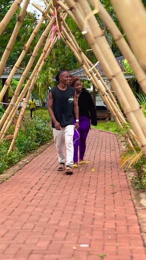 Couple Walking Through Bamboo Archway in Nature