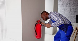 Checking Fire Extinguisher. Safety And Emergency Prevention