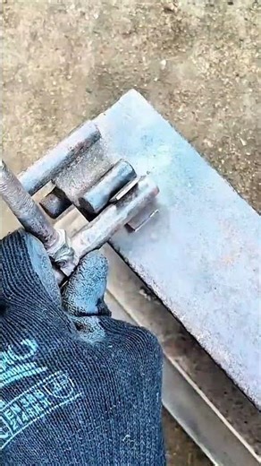 Gloved hand steadies steel—beam aligned