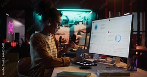 Portrait of a Beautiful Happy Female Project Manager Working in Creative Agency, Reviewing Marketing Strategy. Black Specialist Using Desktop Computer, Analysing Data, Thinking and Solving Problems