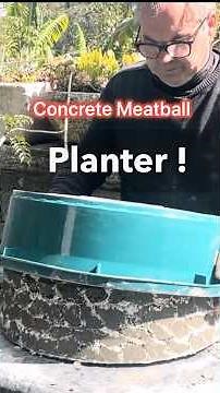 Rolling cement balls coating them with white cement to make a concrete planter