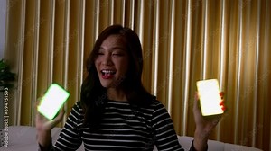 Happy young Asian women beautiful bloggers use headphones and recording video on smartphones for social media application. Freedom and active lifestyle concept, Communicate sales to via live video.