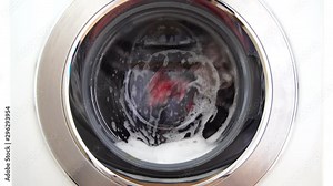 Modern washing machine cleaning clothes.
