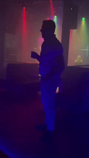 Club Dance Performance Under Colorful Lights