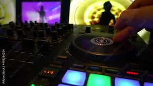 video dj controller 4 channels video 3 screens flashing preset buttons with sihouette shadow gogo dancers dancing in front of night club guests and entertainer scratching the digital turntables 3-4