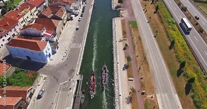 PORTO, PORTUGAL. Aerial 4K view of the scenic backdrop to Porto, crossed by magnificent river, bridges and roads. Top view of the boat cruise along the Douro River.