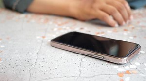 Download man hand picking up smart phone mobile to receive a call for free