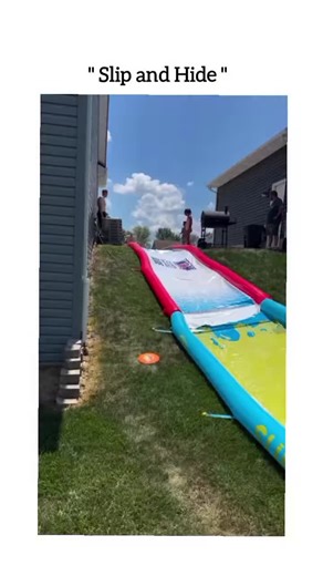 for fun 😊 on Instagram: "This viral reel features a lighthearted backyard moment where a young man attempts to slide down a long, colorful inflatable slip-and-slide positioned on a grassy hill. As he gains momentum and dives headfirst, his speed carries him with such force that he doesn't just reach the end—he actually slides directly underneath the inflated side bumper of the mat. The video captures the hilarious and unexpected sight of him disappearing entirely beneath the yellow and blue pla