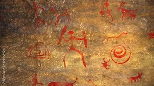 Cave paintings of primitive man. Ocher red paint. Hunters hunt deer, cock a food. Caveman, Neanderthal, drawings in the cave