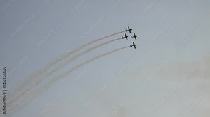 Four airplanes in formation on airshow. Aerobatic team performs flight at air show