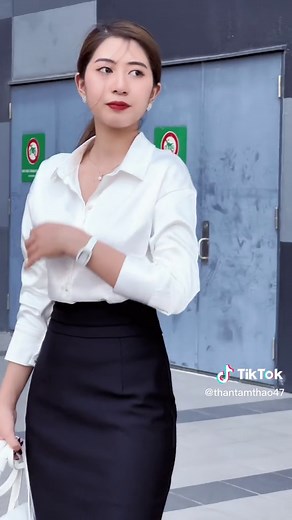 Urban Fashion: Stylish Woman in White Blouse and Black Skirt