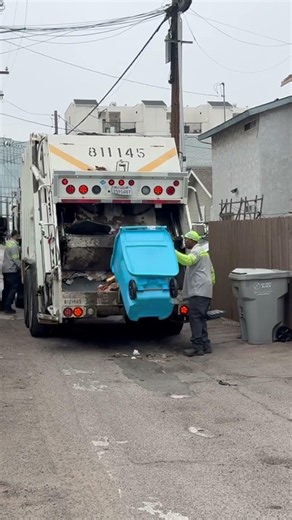 Garbage Truck Collecting New Recycle Carts