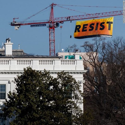 Activists with the environmental organization Greenpeace climbed a construction crane to hang a large banner that people could see from The White House Lawn http://cnn.it/2kl6DMD | CNN