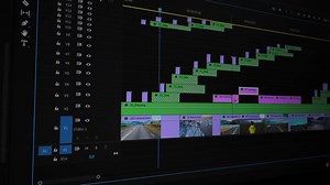 Close-up of detailed multi-track editing timeline with audio layers, Colorful interface shows layered clips, effects, and synchronized waveforms during post-editing.