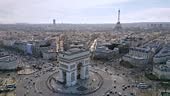 Triumphal arch or Arc de Triomphe and car traffic on roundabout with...