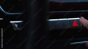 Red emergency button flashing Interior of modern luxury car. Details of automatic transmission gear shift, multimedia control system, car control panel, Air Vent and dashboard inside. Prestige sport