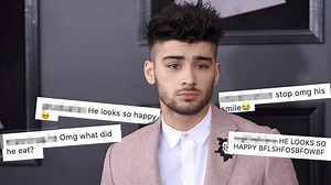 Zayn Malik looks adorably happy as he poses with a fan at a restaurant