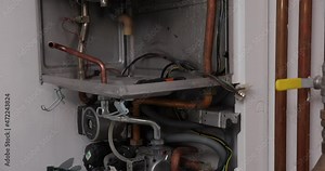 Maintenance, plumber and repair service engineer working with house gas heating boiler. Professional worker servicing the heating system. Repairs Gas boilers.