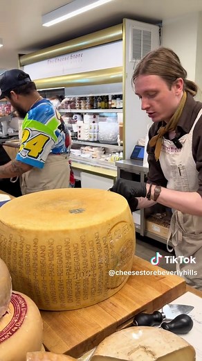 Cutting Parmigiano Reggiano Cheese Wheel in Beverly Hills