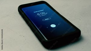 Alarm clock going off on smartphone with Good Morning text on display