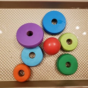 Making music with my little one (3 months old). Replace the toys on your baby gym with cookie cutters and give your baby a plastic link for each hand. That's it! They can learn how to play their first instrument in this sensory activity. Also great for exploring cause and effect. Note: You can also use jingle bells or an old plastic Easter egg filled with something inside to make a maraca-like sound. Also to note: you can make your own baby gym out of pvc pipe! @homedepot https://www.instagram.c