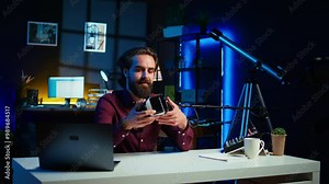 Close up shot of futuristic VR goggles held by man reviewing them for viewers. Internet star filming technology channel vlog for gadget enthusiasts, showcasing virtual reality headset, camera B