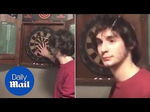 Dart flies into man's HEAD... but he doesn't seem to notice - Daily Mail