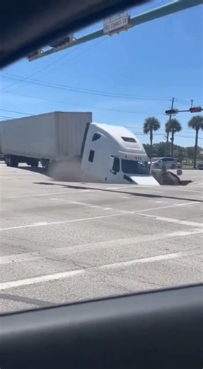 A massive sinkhole opened without warning in a California roadway, causing part of the street to collapse and leaving drivers stunned as a large slab of concrete tilted sharply into the ground. Video of the scene shows the pavement lifted at an extreme angle, resembling a ramp, as the ground beneath gave way. The incident occurred during daylight hours in a busy area, but officials say quick reactions and good timing prevented injuries. No vehicles or pedestrians were caught in the collapse, and