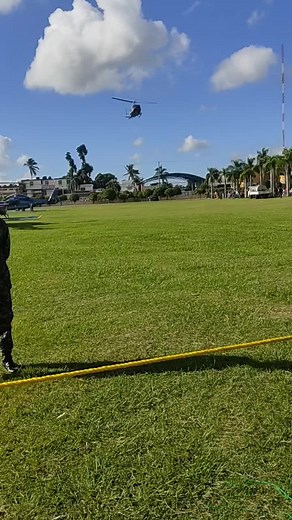Military Helicopter Flyover in Tropical Landscape