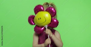 Girl holds balloon in the form of flower. Happy four years old girl. Chroma Key