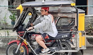 Eric Fructuoso goes viral after sharing a photo of himself on a driver's side of a parked tricycle