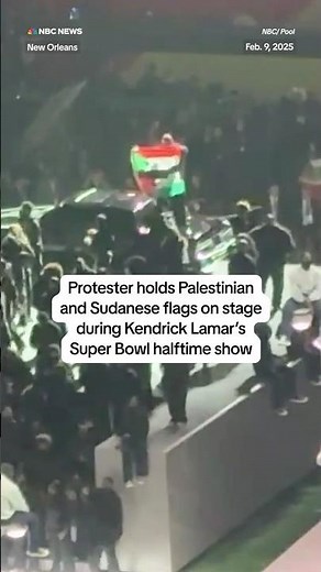 Protestor holds Palestinian and Sudanese flags on stage during Kendrick Lamar's Super Bowl halftime