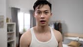slow motion with shoulder shot confident asian man facing camera like...