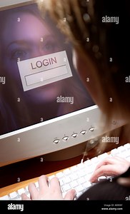 Woman logging in to computer Stock Photo - Alamy