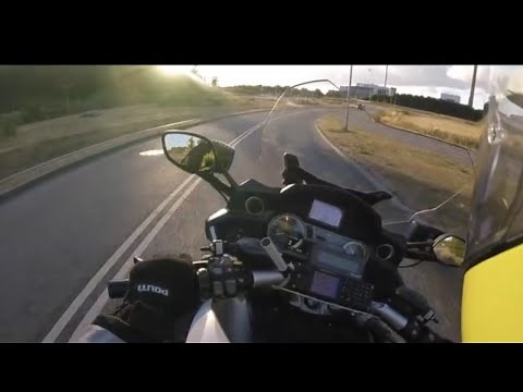 High speed pursuit. Police motorcycle chasing powerful BMW car