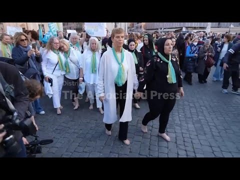 Palestinian and Israeli mothers lead dozens in barefoot march for peace in the center of Rome