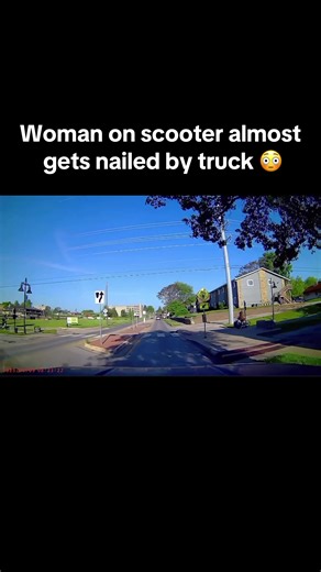 Woman on Scooter Escapes Close Call with Truck