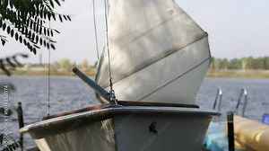 A sailboat is tied up in a yacht club. Travel, tourism, recreation, free lifestyle, sailing.