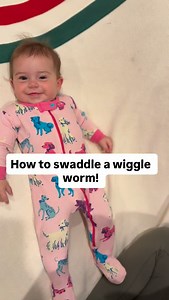 this short sleeve arms out sleep sack slides on so easy! My baby can still move and roll around, but she’s not able to get her legs trapped in the crib bars and it’s so easy to put on! ￼#rollingbaby #swaddelini #bestsleepsack #babysleeptips #wearableblanket | Swaddelini