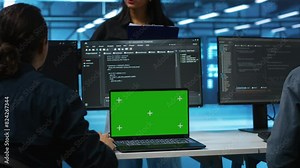 Manager in server hub supervising engineers looking for misconfiguration using isolated screen device. Woman coordinating experts mending data center bugs with mockup notebook, close up panning shot