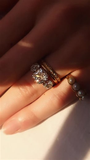 Andria Barboné Jewelry on Instagram: "Marielle 3.23 ✨ featuring three beautiful, chunky old mine cut diamonds with excellent finger coverage. Three-stone rings often called, “triology” rings gained popularity during the Victorian era ~ driven by romantic symbolism ~ becoming prominent as engagement rings in the 19th century. This Marielle has that classic Old Mine Cut look we seek out, with a center stone whose beauty and faceting we can’t get enough of! We paired her with our Moxy + Jane Band