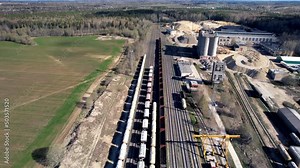 Cement freight cars on railway. Transport bulk materials on railroad. Tank cars near industrial plant.