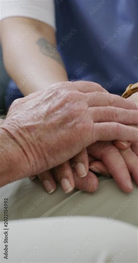 Caregiver, comfort and holding hands with senior person for empathy, medical support and wellbeing. Nurse, consoling and elderly patient for understanding, assisted living and recovery advice in home
