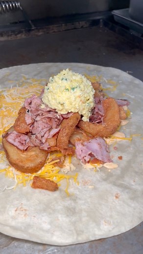 Crispy ham egg and cheese breakfast burrito with seasoned potatoes #grubspot | Grubspot.