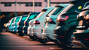 A row of cars parked in a parking lot