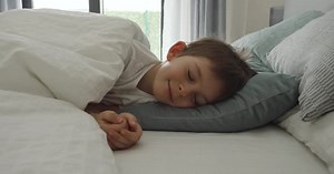 Child Sleeping Peacefully in Bed at Home