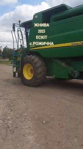 John Deere Combine Harvester in Rural Setting
