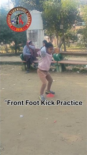 Kids Taekwondo training with squats and front foot kicks to build strength, balance, and discipline.