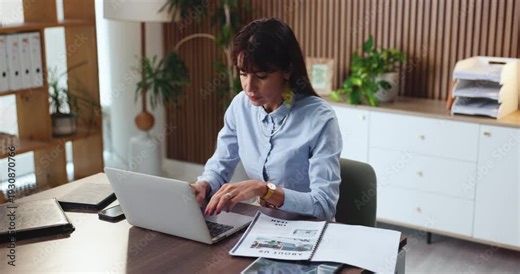 Reading, paperwork and woman with laptop in office, review cv or screening online for company vacancy. Recruitment, hr manager or talent scout with candidate resume for evaluation, pc or typing email