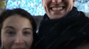 Fun couple in the city at night taking a selfie, as seen from the camera's p.o.v. Shot on RED Epic.